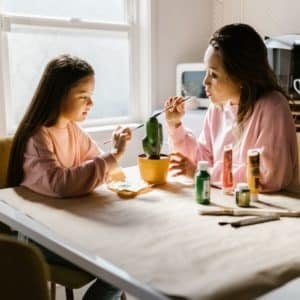 mother and daughter painting a ceramic cactus